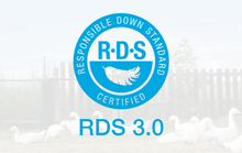 Load image into Gallery viewer, A light blue circular seal for "Responsible Down Standard Certified RDS 3.0" featuring a feather icon, overlaid on a background image of white geese.